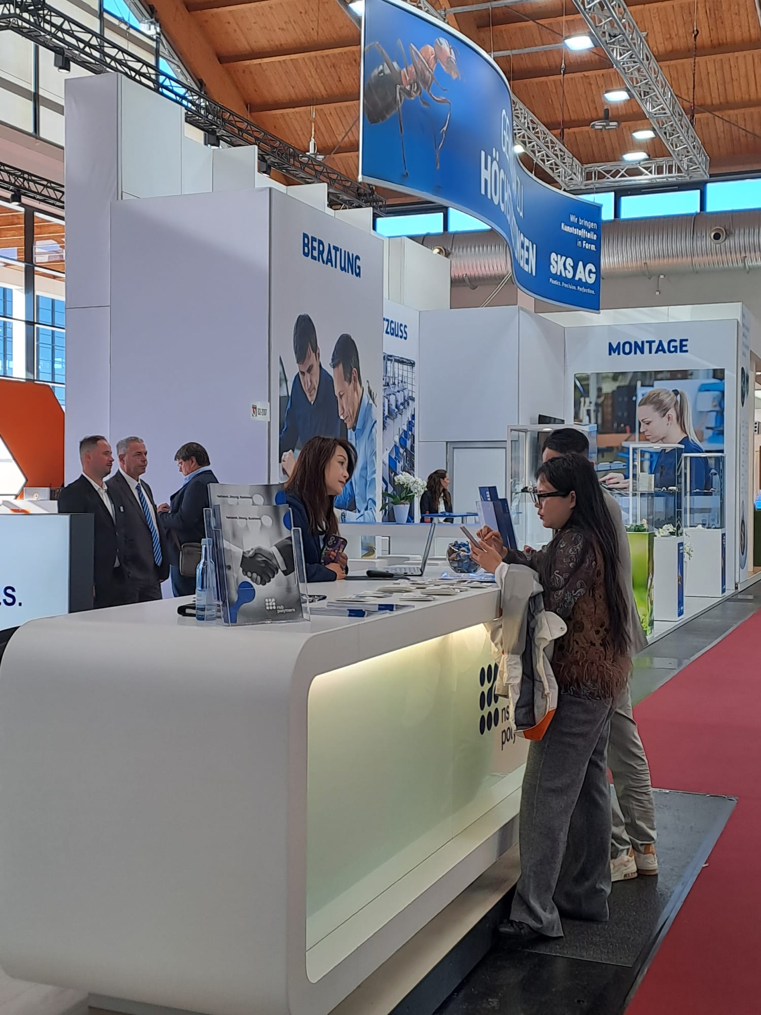 A visitor at the NSB Polymers counter, FAKUMA 2026